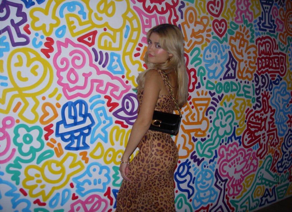 Riana with a colourful wall background - expression of creativity